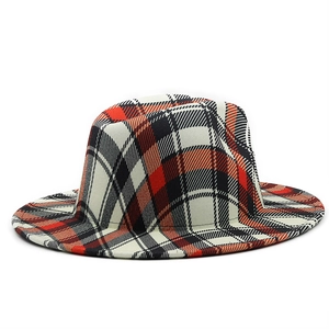 Detail of red and black British plaid pattern on a flat brim wool fedora jazz hat
