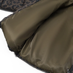 Detail of dark olive green lining and smooth zipper on the leopard print jacket