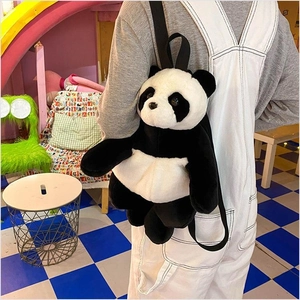 Detail view of plush panda backpack with soft black and white fur and adjustable straps