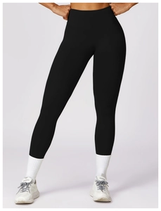 Detail shot of high-waisted black yoga pants showing slim fit and matte fabric texture