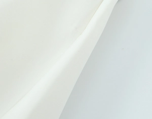 Close-up of white elastic textile fabric showing smooth plain weave texture and high-quality detail
