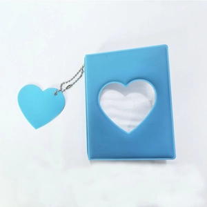 Detail of blue heart cutout 3-inch photo album with a matching heart charm and silver chain