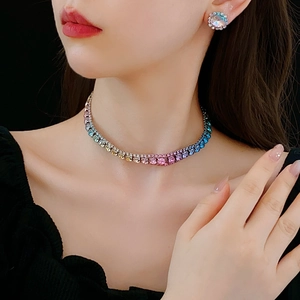 Close-up of elegant gradient crystal necklace and stud earrings set on a model