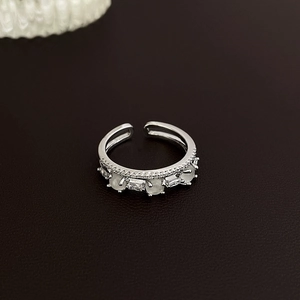 Detailed shot of silver adjustable ring with opalescent gems and clear crystals