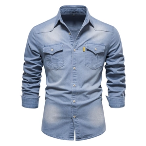 Detailed view of light wash denim shirt featuring flap chest pockets and buttons