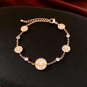 Macro detail of 18K gold plated bracelet showing hollow circle charms with star crystals