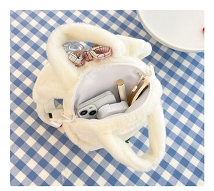 Internal view of plush avocado bag showing space for phone, earphones and cosmetics