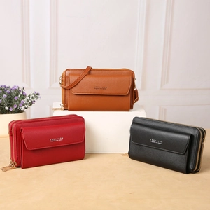 Crossbody phone bag with dual zippers and front flap in brown, red, and black faux leather