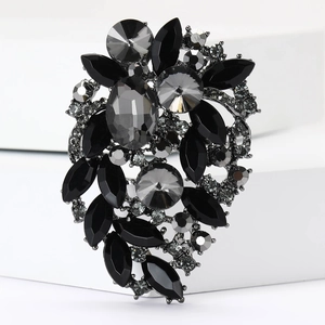 Close-up of vintage-style rhinestone brooch with grey crystals on a gunmetal base