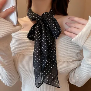 Chic black and white polka dot scarf necklace tied as a bow for elegant women