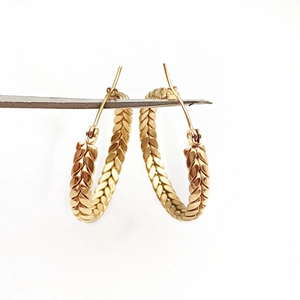 Classic 18K gold plated stainless steel hoop earrings with woven texture on white background