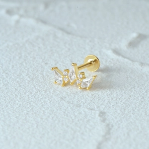 Macro shot of gold threaded flat back earring featuring geometric trapezoid and round zircons