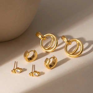 Three-piece gold stainless steel earring set with zircon studs and polished hoops