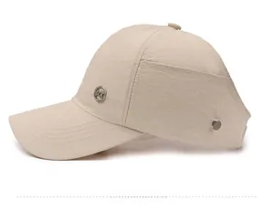 Side view of beige quick-dry ponytail visor hat with metal logo and adjustable buckle