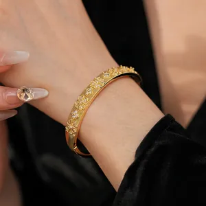 Elegant gold plated floral clover bangle with sparkling cubic zirconia and brushed finish
