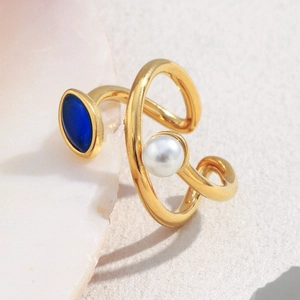 Detailed macro shot of an 18K gold-plated adjustable ring with blue gemstone and pearl