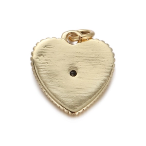 Detail of a gold heart charm with a brushed metal texture and top ring for DIY jewelry