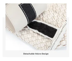 Detail of cream woven handbag with a black detachable velcro strap design closeup