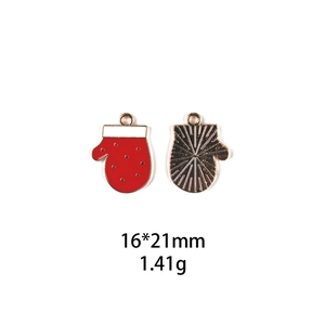 Macro view of Christmas glove enamel charm showing front red oil and back metal texture