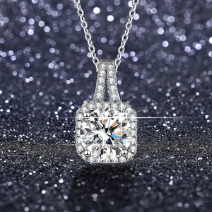 Macro shot of 1 carat moissanite halo pendant with brilliant round cut and square halo