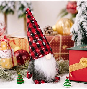 Close-up of a Christmas gnome with red and black plaid hat amidst festive decorations