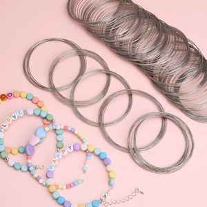 DIY jewelry kit with memory steel wire coils and colorful beaded bracelets with charms