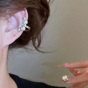 Detailed view of silver zircon pearl ear cuff on ear without piercing for women