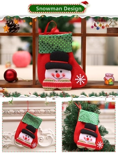 Detail of red Christmas stocking with green sequins and a 3D snowman figurine decoration