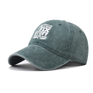 Washed green cotton baseball cap with vintage white text print and curved brim