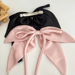 Elegant satin bow hair clips in black and pink with durable metal spring fasteners