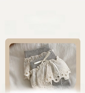 Detail of grey socks featuring white lace trim and a delicate silk bow accent