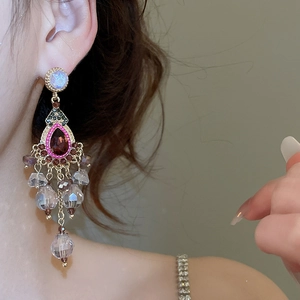 Detail of vintage chandelier earrings with colorful crystal tassels and gems