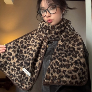 Stylish leopard print plush scarf for women featuring warm thick knit texture and brand tag