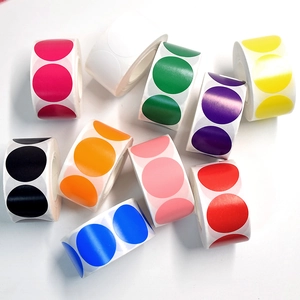 Macro shot of 10 colorful round adhesive label rolls for organizing and sealing items