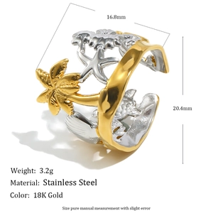 Macro detail of 18K gold-plated stainless steel ring with sea star and palm tree motifs