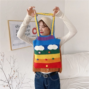 Detailed knit of rainbow crochet tote bag featuring white cloud and 3D puff decorations