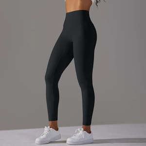 Detailed side view of high-waisted black yoga pants highlighting body curves and fabric texture