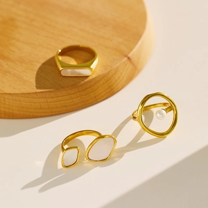Luxury gold plated ring set with mother of pearl and pearls on minimalist display