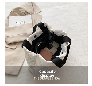 Top view of white quilted tote bag showing large capacity for wallet and phone