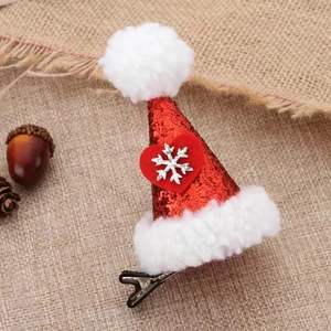 Red sequin Christmas hat hair clip with white fur trim and silver snowflake detail