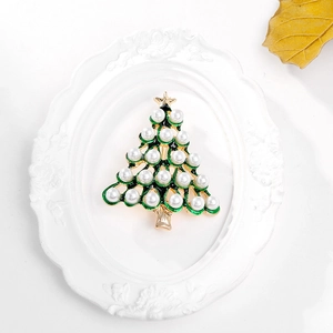 Golden Christmas tree brooch with green enamel and white pearls on elegant white background