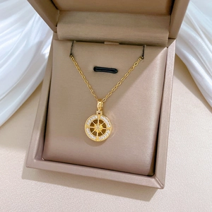 Detail of gold starburst necklace with crystals inside a premium jewelry gift box