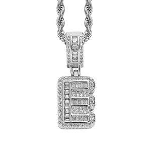 Macro shot of silver hip hop pendant letter E with baguette cut cubic zirconia stones