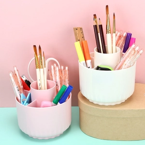 Pink and white rotating desk organizer with five compartments for stationery storage