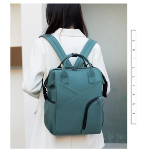 Detailed back view of a dark green nylon diaper backpack with large capacity