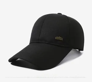 Detail view of cotton baseball cap featuring a vintage copper mountain metal badge