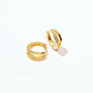 Detailed close-up of S925 sterling silver stamp on golden double hoop earrings