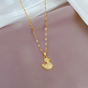 Close-up of golden titanium steel necklace featuring a sparkling crystal duck pendant