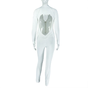 Detail of white long sleeve bodysuit featuring a unique heart-shaped cutout on the back