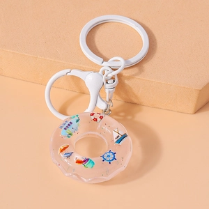 Detail of resin lifebuoy keychain with marine elements and safety education tag